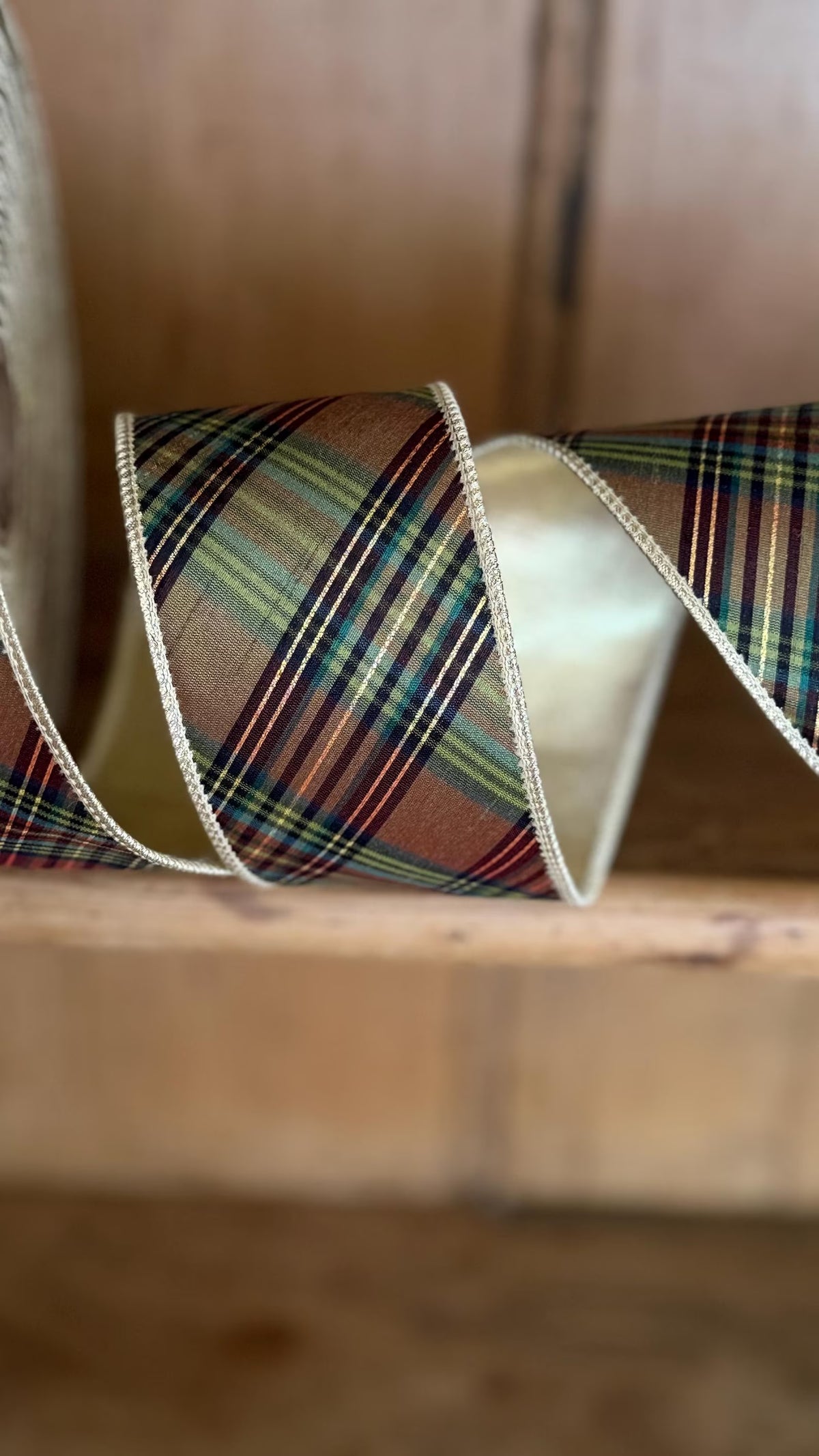 Heritage equestrian plaid wired ribbon in green, brown and burgundy with metallic gold reverse