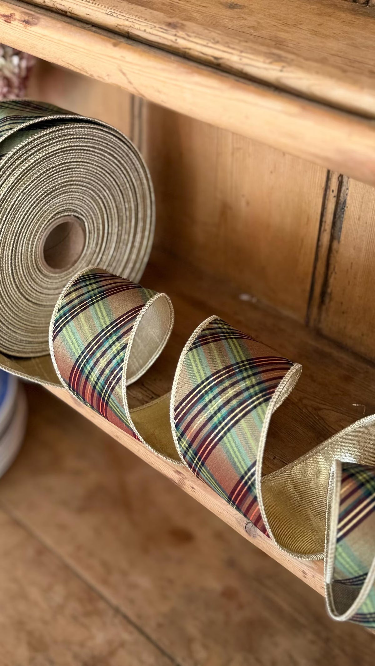 Heritage equestrian plaid wired ribbon in green, brown and burgundy with metallic gold reverse full roll.