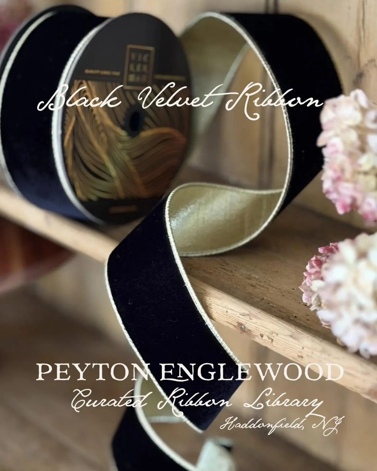 A close-up of black velvet ribbon with a metallic gold inner side and white edge, draped over a wooden surface. Rolls of the ribbon are visible in the background, along with decorative pink flowers and overlaid text reading 'Black Velvet Ribbon' and 'PEYTON ENGLEWOOD Curated Ribbon Library'.