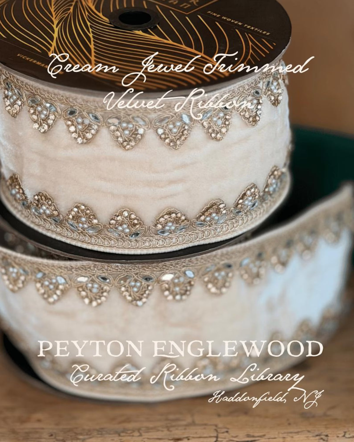 Cream velvet ribbon with jeweled trim, shown wound on a spool and unrolled. The trim features repeating heart motifs with rhinestones and metallic detailing. Text says cream jewel trimmed velvet ribbon, Peyton englewood curated ribbon library haddonfield, New Jersey.