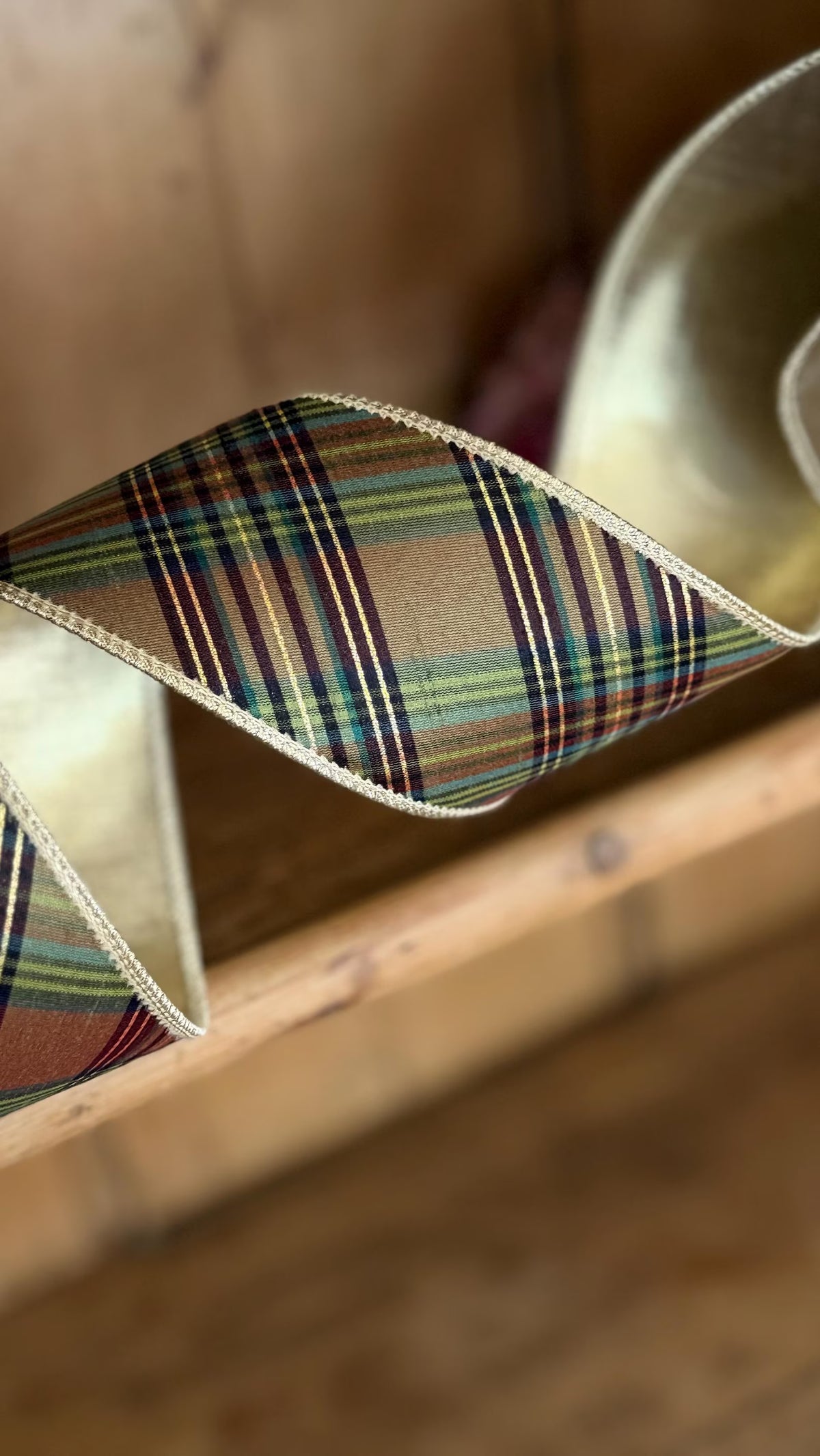Heritage equestrian plaid wired ribbon in green, brown and burgundy with metallic gold reverse