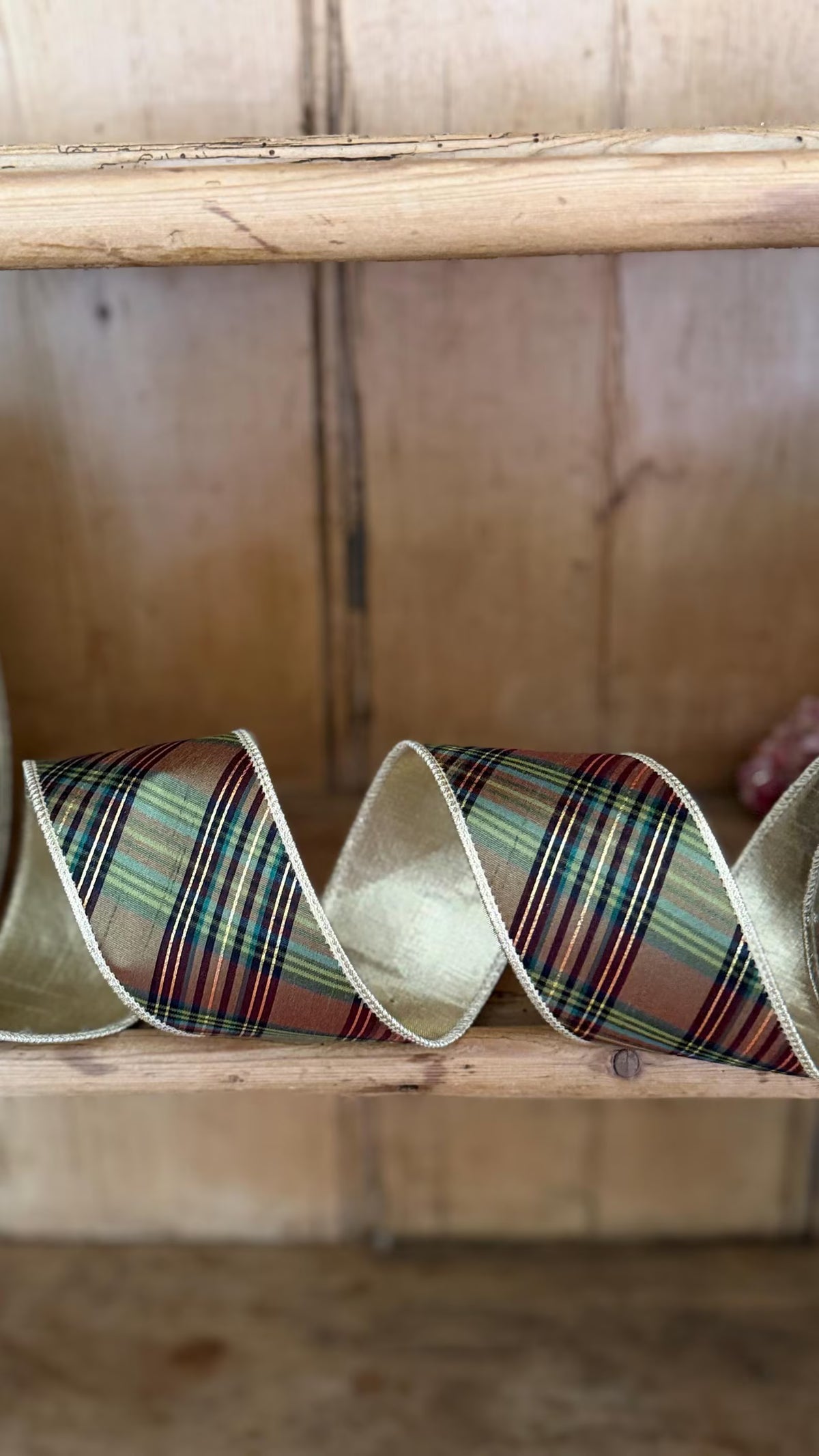 Heritage equestrian plaid wired ribbon in green, brown and burgundy with metallic gold reverse on English Country antique hutch. 