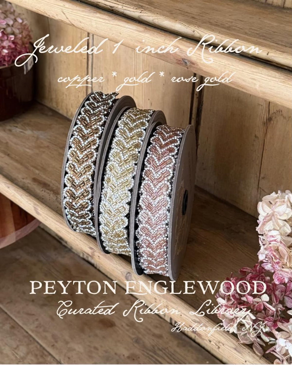 Three spools of patterned ribbon displayed on rustic wooden shelves, with overlaid text reading 'Jeweled 1 inch Ribbon' and 'PEYTON ENGLEWOOD Curated Ribbon Library.' The ribbons show metallic chevron-like patterns in copper, gold, and rose gold tones.